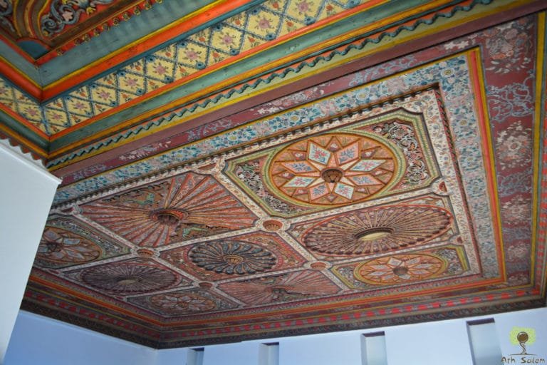 A painted timber ceiling worked to its centre rosette.
