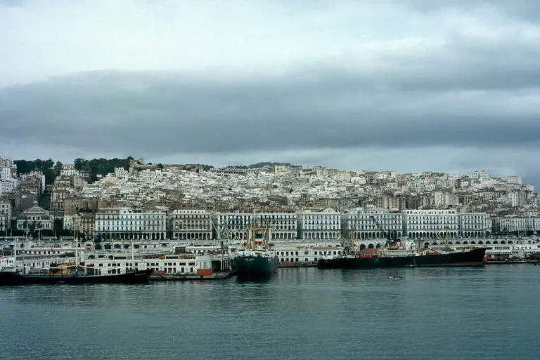 A historic photograph of the waterfront and the medina above it.